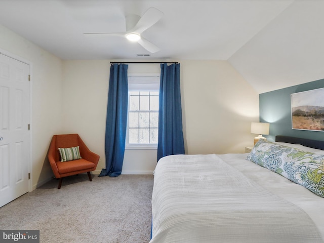 bedroom with a ceiling fan, visible vents, carpet floors, baseboards, and lofted ceiling