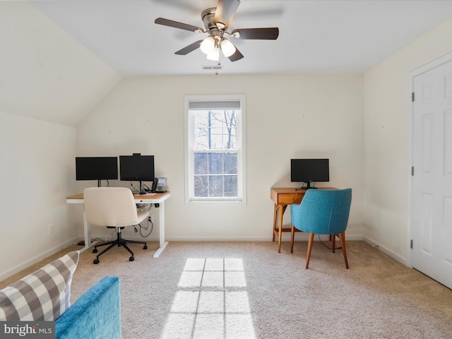 carpeted office space featuring visible vents, lofted ceiling, and baseboards