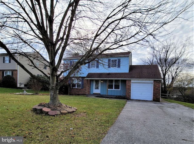 traditional-style home with a garage, driveway, a front yard, board and batten siding, and brick siding