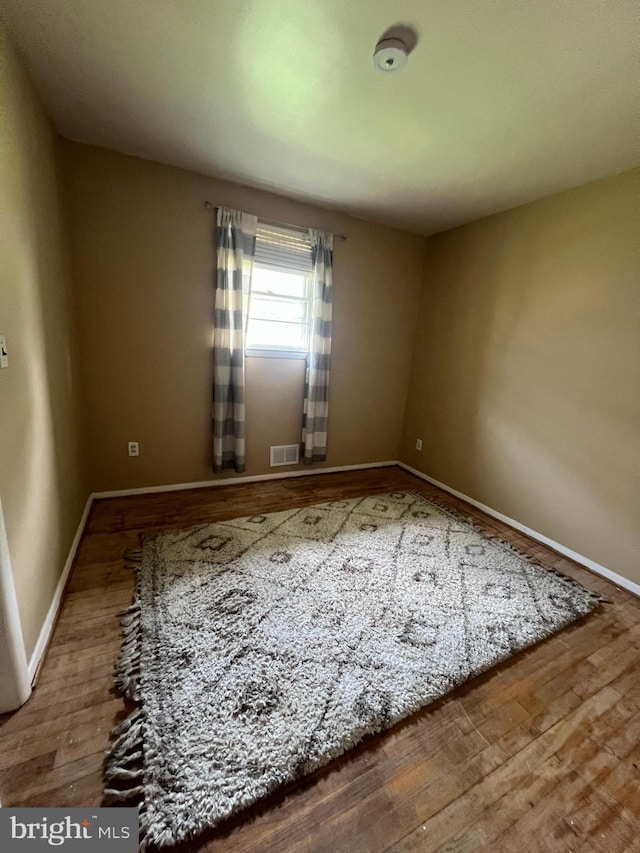 8211 Beach Dr, Baltimore, MD 21222 - unfurnished room with wood finished floors and baseboards