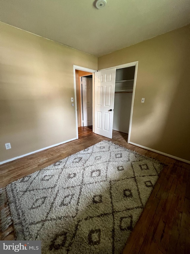 8211 Beach Dr, Baltimore, MD 21222 - unfurnished bedroom featuring baseboards and wood finished floors