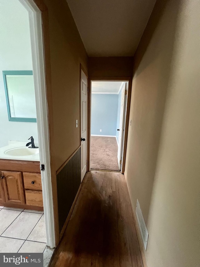 8211 Beach Dr, Baltimore, MD 21222 - corridor with a sink and light wood finished floors