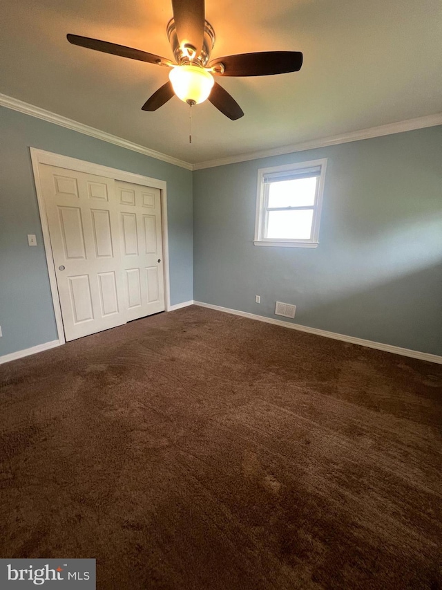 8211 Beach Dr, Baltimore, MD 21222 - unfurnished bedroom with crown molding, baseboards, dark colored carpet, a closet, and a ceiling fan