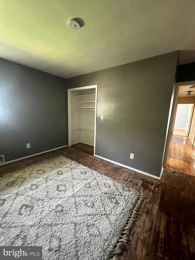 8211 Beach Dr, Baltimore, MD 21222 - unfurnished bedroom with baseboards, wood finished floors, and a closet