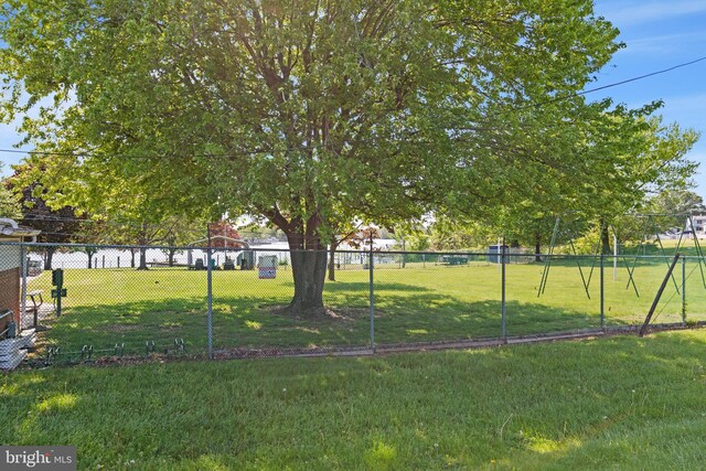 view of community with a yard and fence