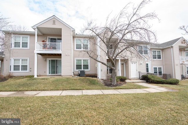 multi unit property featuring a balcony, central AC, and a front lawn