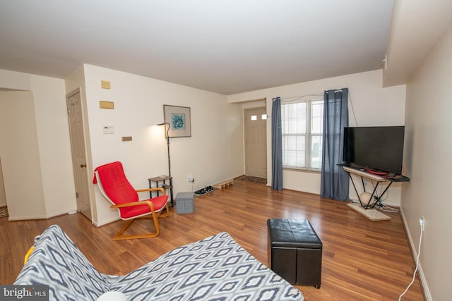 living room featuring baseboards and wood finished floors