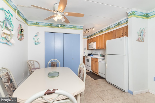 dining space with baseboards, a ceiling fan, light tile patterned flooring, and crown molding