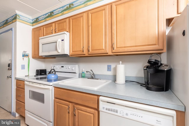 kitchen featuring ornamental molding, white appliances, light countertops, and a sink