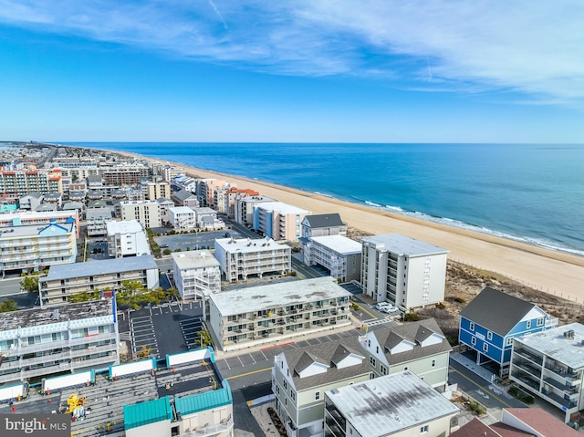 drone / aerial view with a beach view and a water view