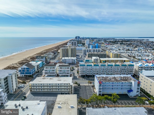 aerial view featuring a water view, a city view, and a view of the beach