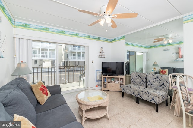 tiled living area featuring ornamental molding and a ceiling fan