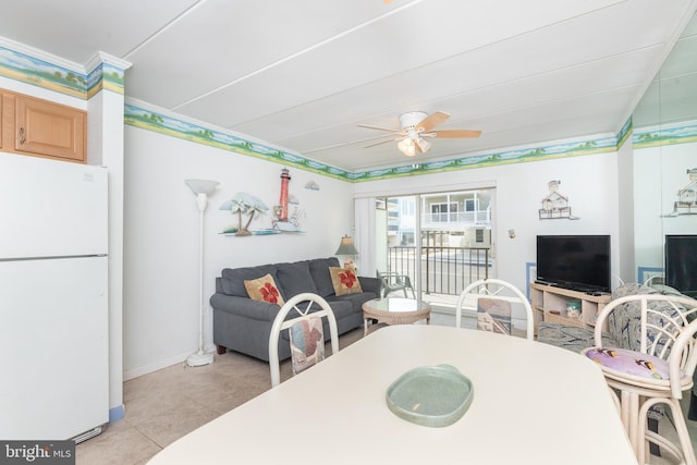 interior space with ornamental molding, baseboards, and ceiling fan