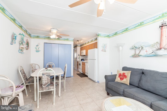 living area featuring light tile patterned floors and ceiling fan