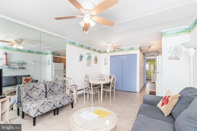 living room featuring a baseboard heating unit, light tile patterned floors, and a ceiling fan