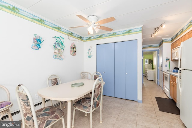 dining space featuring light tile patterned floors, baseboard heating, ceiling fan, and track lighting