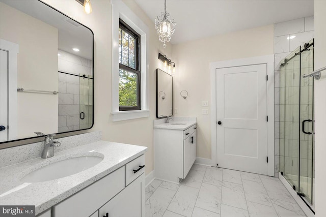 bathroom featuring marble finish floor, two vanities, a sink, and a shower stall