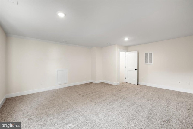 carpeted empty room with recessed lighting, visible vents, and baseboards