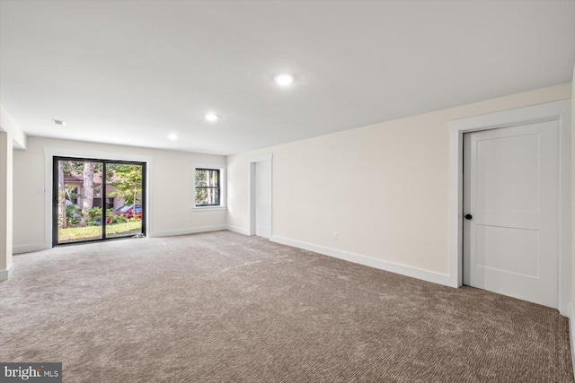 carpeted empty room featuring recessed lighting and baseboards