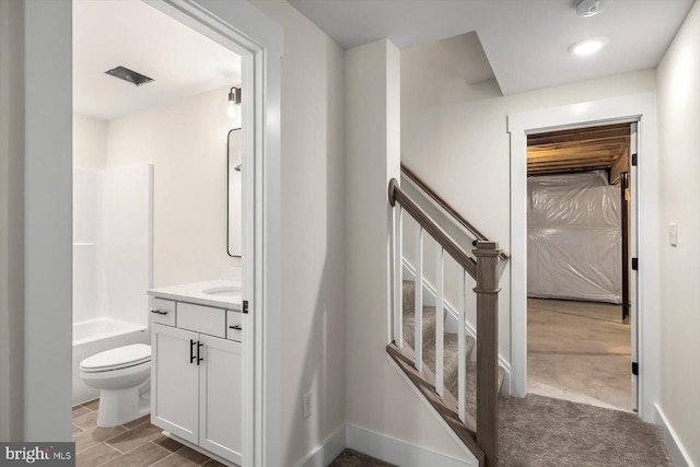 bathroom with  shower combination, vanity, and toilet