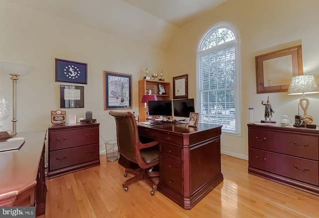 office space with baseboards and light wood-style flooring