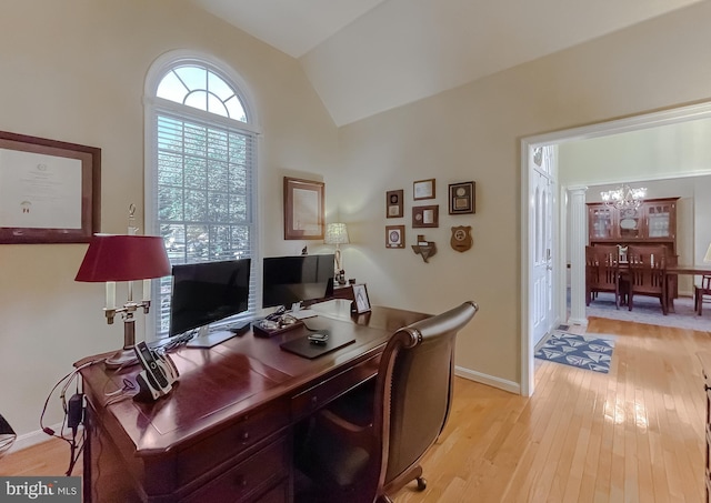 home office with baseboards, lofted ceiling, a notable chandelier, and light wood-style flooring