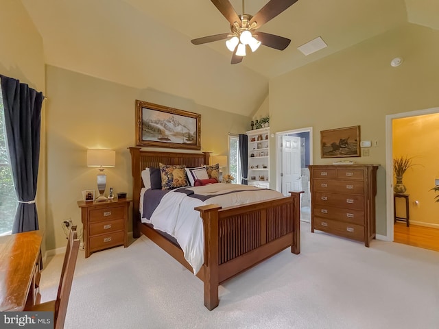 bedroom featuring light carpet, high vaulted ceiling, baseboards, and a ceiling fan