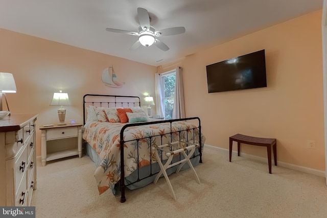 bedroom with light colored carpet, visible vents, baseboards, and ceiling fan