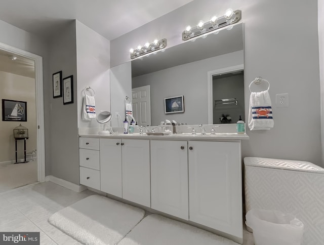 bathroom featuring baseboards, vanity, and tile patterned flooring