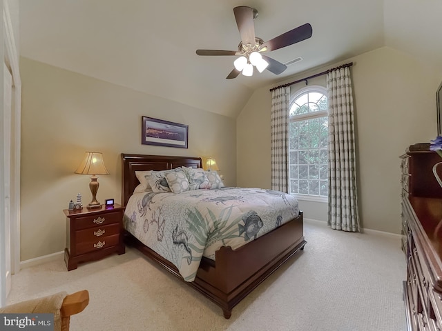 bedroom with lofted ceiling, light colored carpet, and baseboards