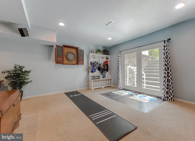 exercise area with visible vents, baseboards, carpet floors, and french doors