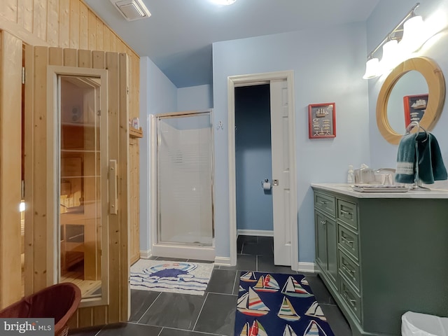 bathroom featuring vanity, visible vents, baseboards, a stall shower, and tile patterned floors