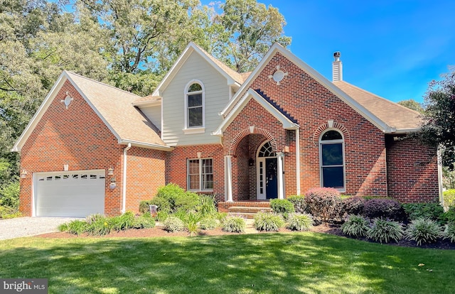 view of front of property with brick siding, a front yard, roof with shingles, a chimney, and an attached garage