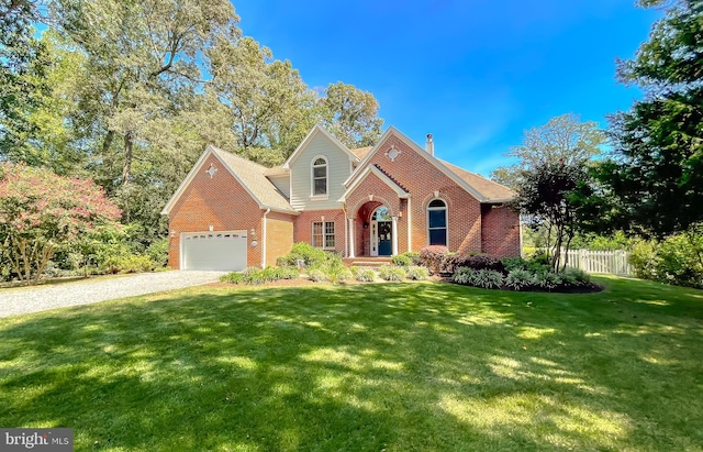 view of front of property featuring a front lawn, brick siding, a chimney, and fence