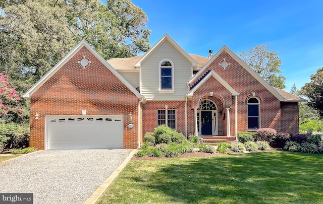 traditional home featuring driveway, a front lawn, brick siding, and an attached garage