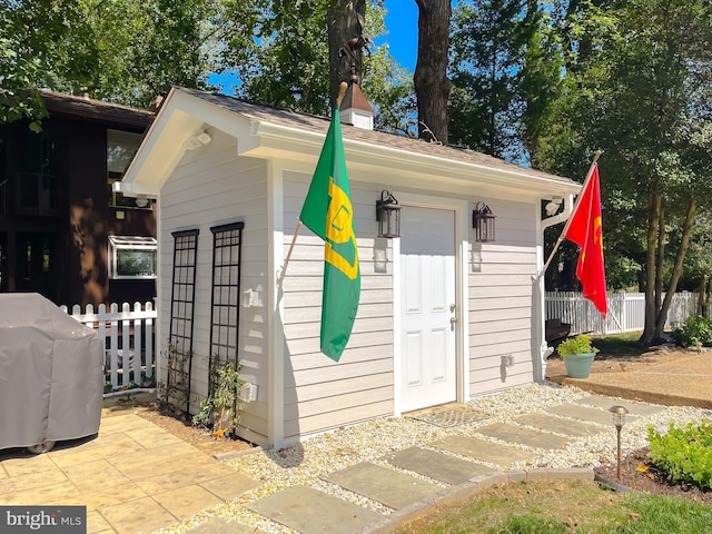 view of outbuilding featuring an outbuilding and fence