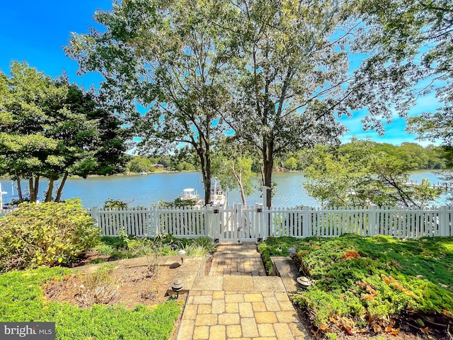 view of water feature with a fenced front yard and a gate