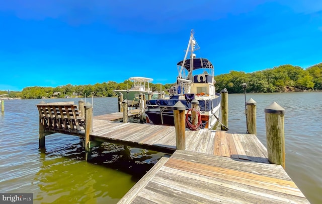 dock area with a water view and boat lift