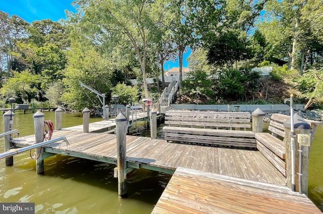 view of dock with stairway and a water view