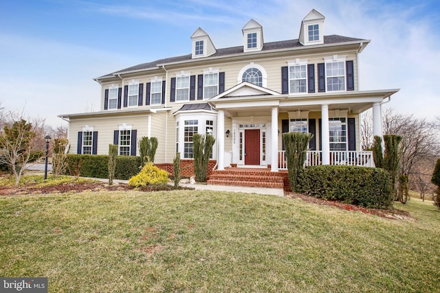 view of front of house with a porch and a front yard