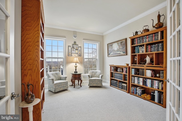 sitting room with crown molding, french doors, baseboards, and carpet floors