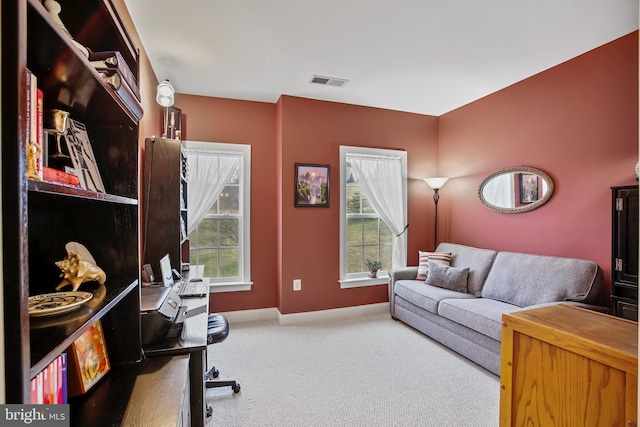 office space featuring visible vents, carpet floors, and baseboards