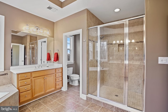 bathroom featuring visible vents, a stall shower, and toilet