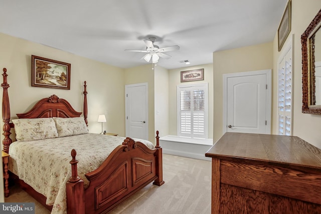 bedroom featuring visible vents, light colored carpet, baseboards, and a ceiling fan