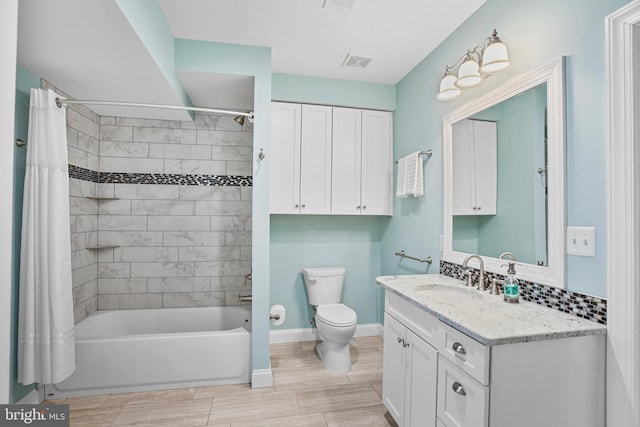 bathroom with visible vents, toilet, shower / bath combo, baseboards, and vanity