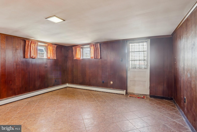 basement with baseboard heating and wood walls