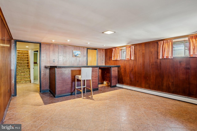 bar with wooden walls, a baseboard heating unit, stairs, recessed lighting, and a bar