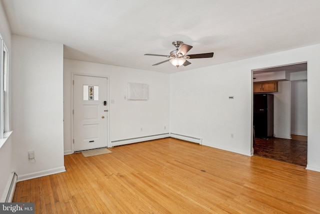 foyer featuring light wood-type flooring, a baseboard heating unit, baseboards, and a ceiling fan