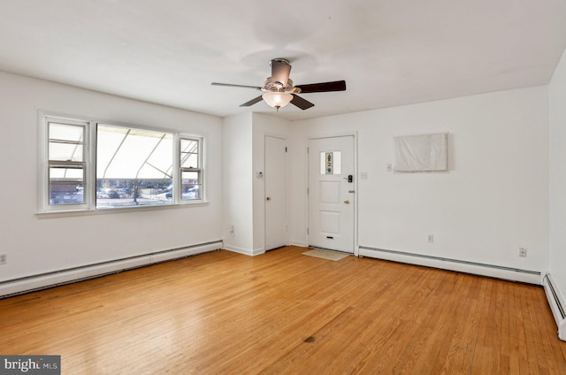 empty room with a baseboard heating unit, baseboard heating, light wood-style flooring, and a ceiling fan