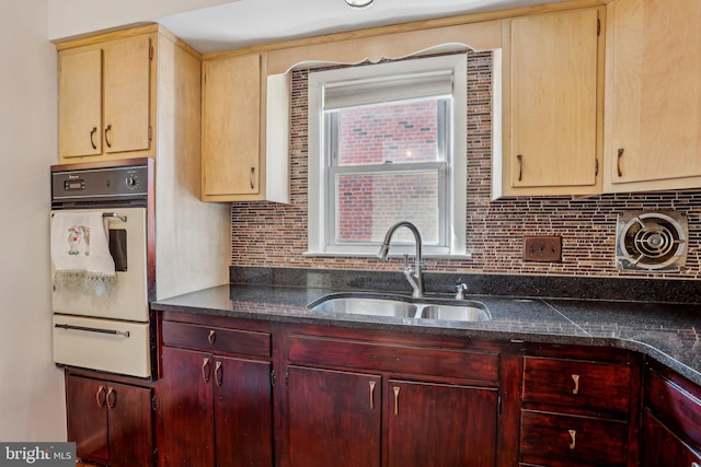 kitchen with a warming drawer, a sink, tasteful backsplash, wall oven, and reddish brown cabinets